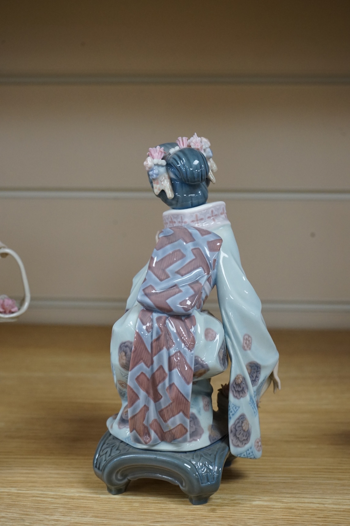 Three Lladro models of seated Geisha. Tallest 23cm
